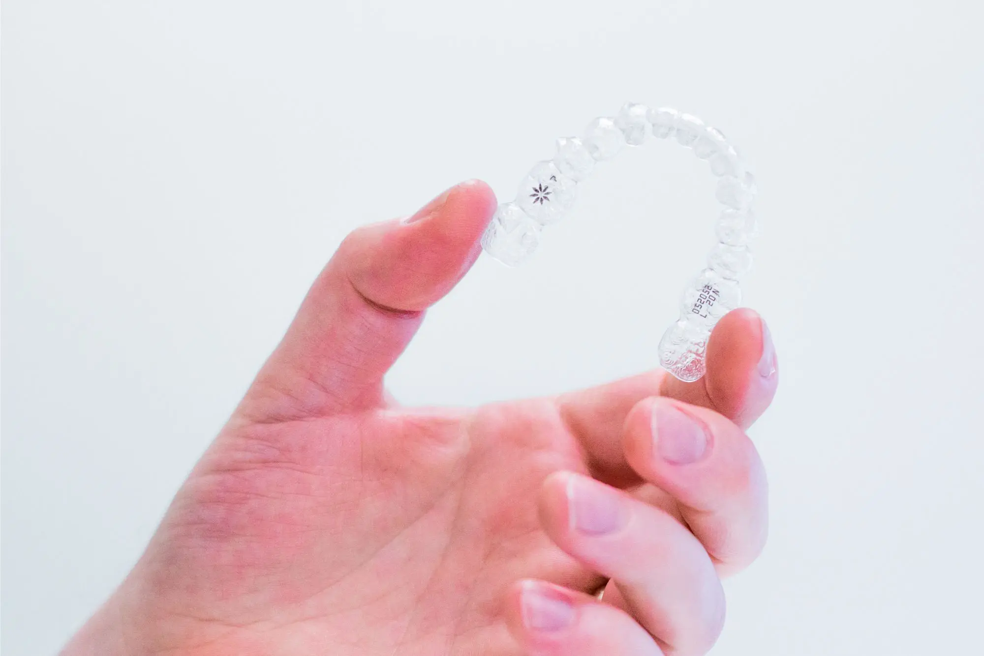 hand-holding-invisalign-aligners Invisalign for Teens