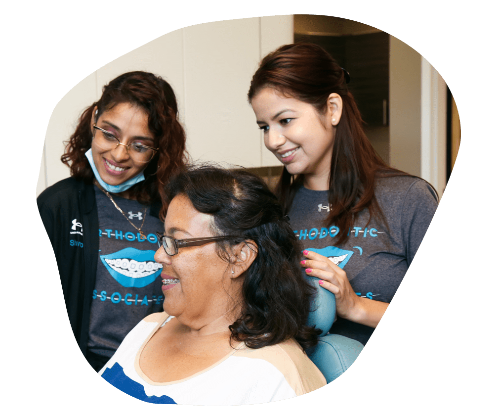 patient smiling with orthodontic associates staff